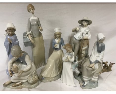 A collection of six Lladro figures to include Dressmaker no 4700, Nao figure of girl praying, Nao figure of girl holding pupp