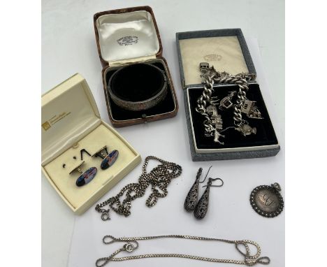 Silver jewellery to include charm bracelet with multiple charms, Norwegian silver and enamel cuff links, bangle in fitted pre