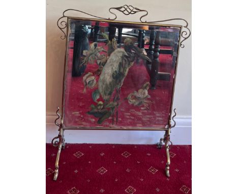A 19thC brass framed mirrored fire screen painted with dodo and flowers. 