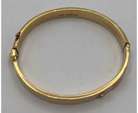 A 15 carat gold hinged bangle, weight 9.8gm. 