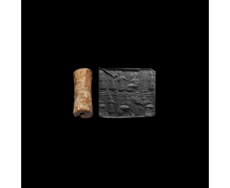 2nd millennium BC. A substantial carved shell cylinder seal with figural scenes in two registers and median ribbed band; abov