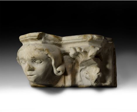 Late 13th century AD. A carved limestone corbel capital with moulded upper edge, female head with centre-parted flowing hair 