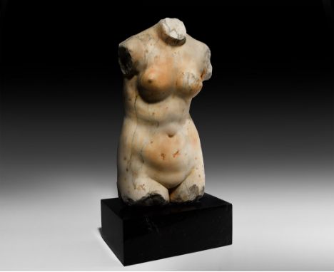 16th century AD and earlier. A torso of Venus carved from veined marble, the goddess depicted standing nude with flat reverse