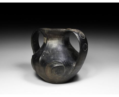 Han Dynasty, 206 BC-220 AD. A ceramic burnished black ware jar with scooped and carinated profile to the neck, two broad stra