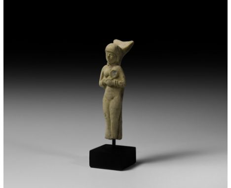 2nd millennium BC. A ceramic figure modelled as a nude female, head inclined slightly to the right, hands clasped at the ches
