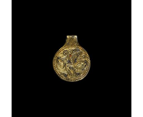 7th century AD. A gilt-silver disc-shaped pendant with a stylised beast formed from interlaced lines within a dashed ropework