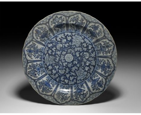 Kangxi Period, late 17th century AD. A blue and white glazed ceramic lotus platter with central dense chrysanthemum and tendr