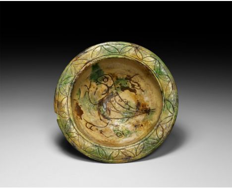 12th-15th century AD. A ceramic sgraffito cup with carinated body, flared foot and broad everted rim, the interior decorated 