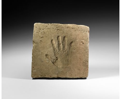 Song Dynasty, 960-1127 AD. A rectangular terracotta tile depicting an advancing lion and rider within a florid frame; the rev
