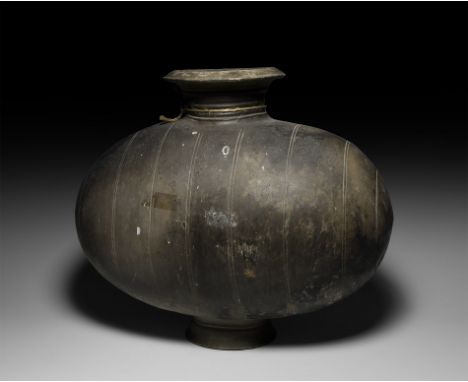 Han Dynasty, 206 BC-220 AD. A broad ceramic greyware vessel with an ovoid body, collared neck, broad chamfered rim and flared