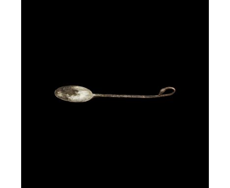 2nd-1st century BC. A silver spoon comprising a flat bowl with slightly raised rim, square-section handle with curled end and