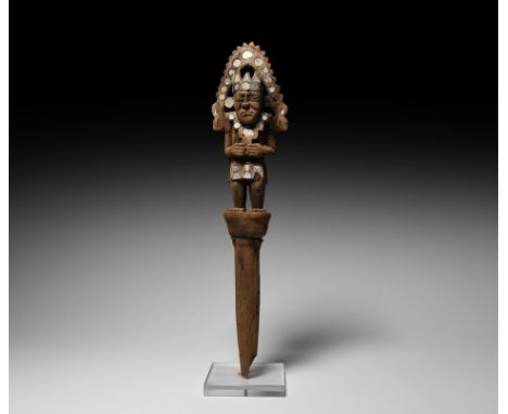 9th-10th century AD. A carved wooden staff head of a Mochica or Chimú ruler, in the form of a standing figure of a man with h