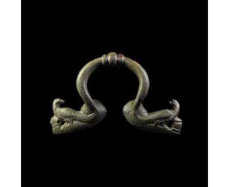 1st-2nd century AD. A bronze handle, possibly from a krater, with penannular body, ribbed central section and terminals forme