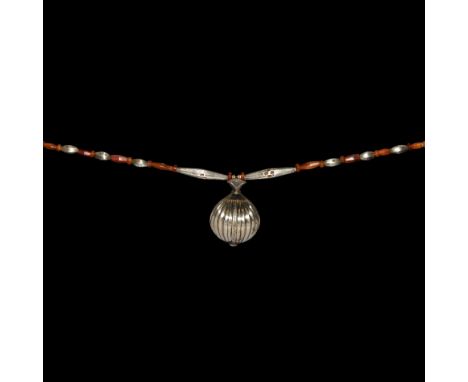 2nd-early 1st millennium BC and later. A necklace composed of carnelian annular and facetted polygonal bicone beads and silve