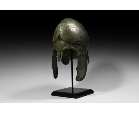 5th-4th century BC. A tinned 'silvered' helmet of Chalcidian type, the bowl forged in one piece with strong ridge and horizon
