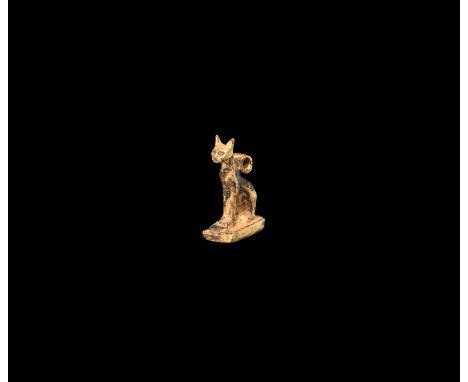 Third Intermediate Period, 1069-702 BC. A gold amulet of Bastet in feline form sitting on a rectangular base; suspension loop