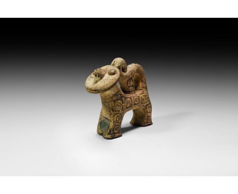 11th-12th century AD. A ceramic stylised standing lion figure with a curled tail and discoid head and mane, humanoid nose, ap