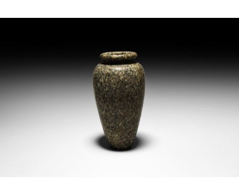 1st-3rd Dynasty, 3218-3035 BC. A speckled granite piriform vessel with flat rim, short neck; rounded shoulder with tapering b