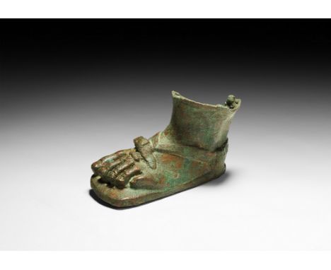 1st-2nd century AD. A hollow-formed fragmentary bronze left foot from a small statue, dressed in a heavy solea sandal with br