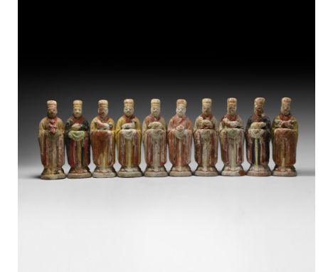 Ming Dynasty, 1368-1644 AD. A group of ten ceramic figures, each modelled in the round wearing a priest's or dignitary's head