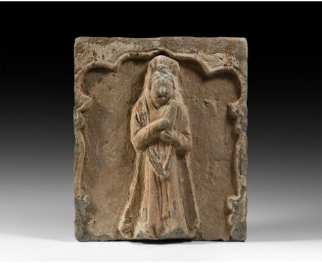 Song Dynasty, 960-1127 AD. A terracotta tile with a facing high-relief figure of a female in floor-length robe with sash to t