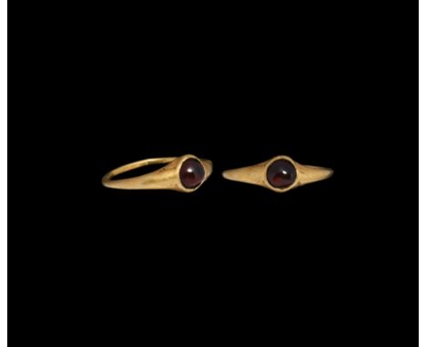 13th-14th century AD. A gold finger ring with hollow-formed bezel, inset garnet cabochon.Cf. Chadour, A.B., Rings. The Alice 