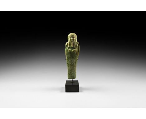 30th Dynasty, 380-343 BC. A substantial pale green glazed composition shabti with tripartite wig and false beard holding agri