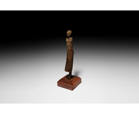 New Kingdom, 1550-1070 BC. A carved wood figure modelled as a striding noble with detachable arms; the shaven head and face n