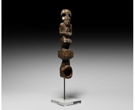 10th-11th century AD. A carved wooden spoon, featuring a sculptured hand holding a cup, upon which stands a figure of a hero 