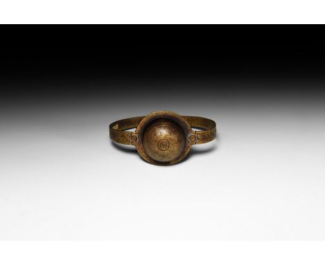 4th-6th century AD. A bronze annular bracelet with adjustable flat-section hoop, decorated with floral motifs composed of sta