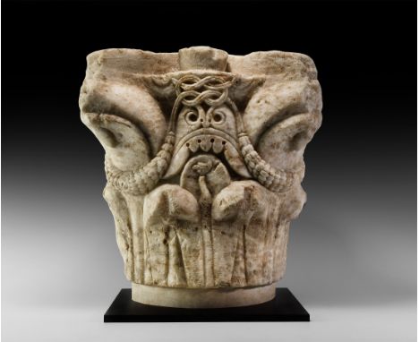 12th century AD. A substantial carved limestone pillar capital for an architectural column or pier, decorated with dense vege