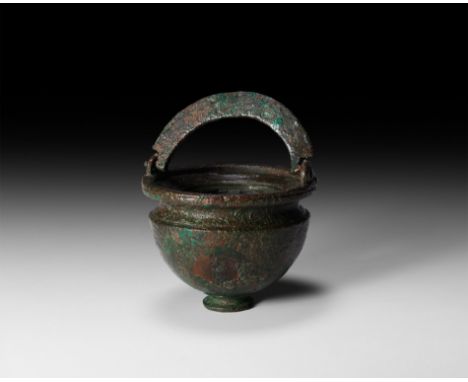 2nd-3rd century AD. A nearly intact bronze vessel with globular body, flattened top once fitted with a bronze lid, circular s