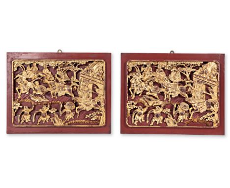 A PAIR OF CARVED AND GILT WOOD PANELS
A pair of carved, painted and gilt decorative wood panels depicting a battle scene outs