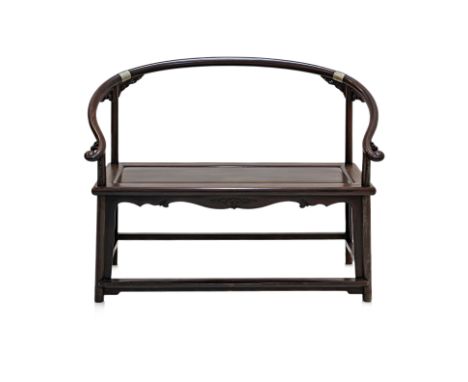A CHINESE BLACKWOOD HORSESHOE-BACK DOUBLE ARMCHAIR The curved top rail with scroll ends and mythical beast carved decoration,