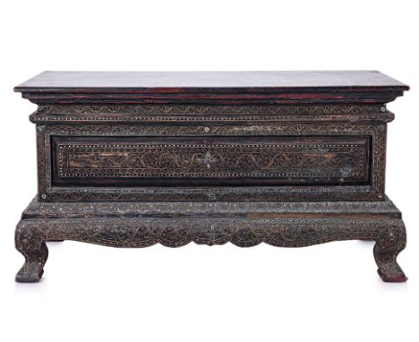 A SOUTHEAST ASIAN GLASS INSET LOW TRUNK
With hinged cover, the front and sides decorated with multi-coloured glass and scroll