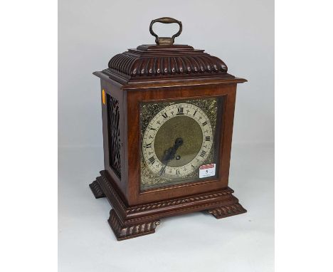 An early 20th century walnut bracket clock, the chapter ring showing Roman numerals with brass spandrels, h.31cm