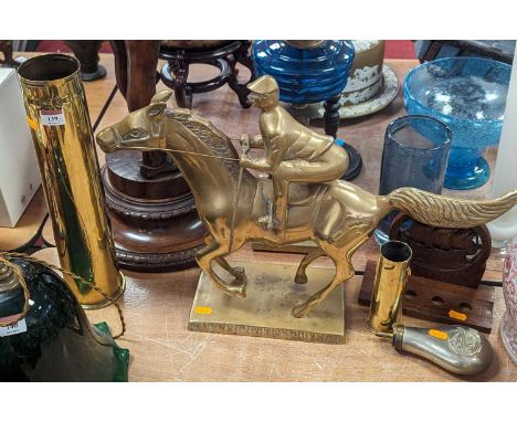 A brass model of a horse &amp; jockey, height 41cm, together with two brass shell cases, a powder flask and carved wood pipe 