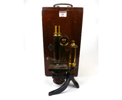 A lacquered brass monocular microscope having an adjustable stage over a Y-shaped foot (incomplete), with wooden case, variou