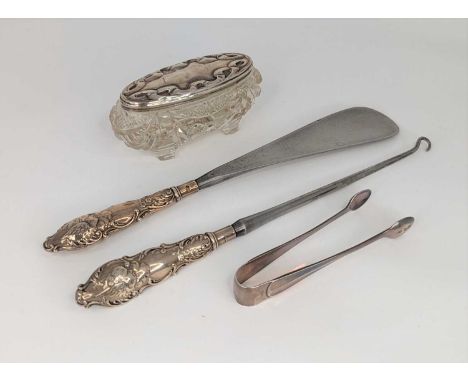 A late Victorian shoe horn with matching button hook having silver collars, together with a silver topped dressing table jar,