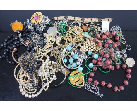 Exotic costume jewellery to include rolled gold bangle, beaded necklaces, brooches, etc