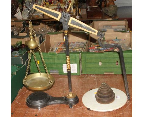 A 19th century cast iron and brass balance scale, height 57cm, together with a graduated set of weights