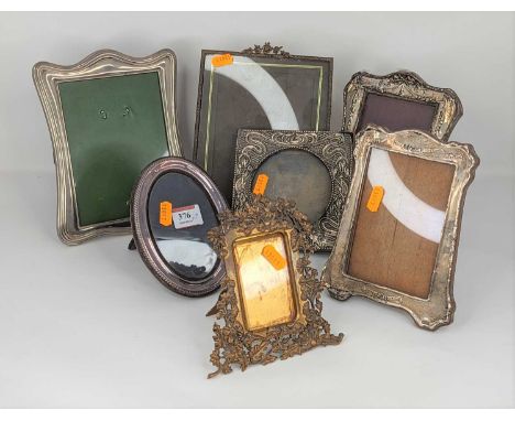 An Art Nouveau silver clad easel photo frame having sinuous floral decoration within beaded border together with various othe