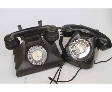 An early 20th century black bakelite cased rotary telephone, w.20cm; together with another similar 