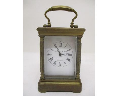 An early 20th century brass miniature carriage clock. The white enamel dial having Roman numerals and inscribed Elliott &amp;