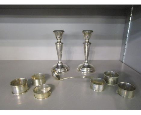 A pair of Elizabeth II silver filled candlesticks, Birmingham 1972/73, mixed silver napkin rings, various dates and makers, a