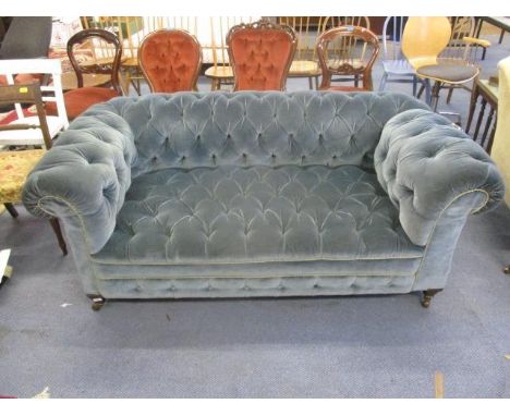 An early 20th century Howard &amp; Co style drop end Chesterfield sofa, button upholstered in blue dralon, on square tapering