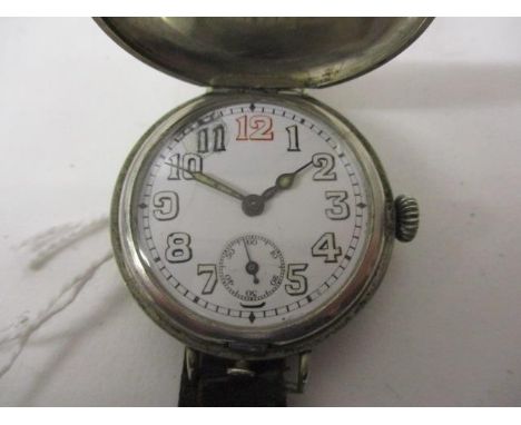 An early 20th century gents, manual wind, nickel cased trench watch. The white enamel dial having Arabic numerals, subsidiary