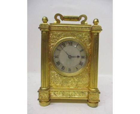 A mid 19th century English carriage clock in the style of Thomas Cole. The gilt brass case having engraved, floral and scroll