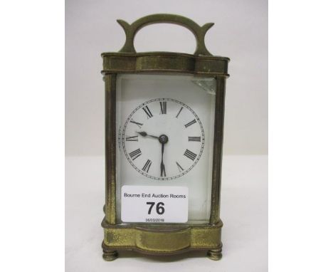 An early 20th century brass carriage clock. The white enamel dial having Roman numerals and blued hands, 6 1/4" h x 3 1/4"w 