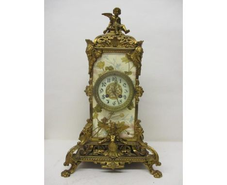 A Victorian gilt metal classical inspired mantle clock with porcelain panels and gilt highlights with Tunnicliffe &amp; co ma